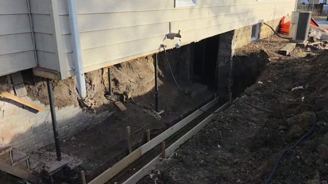Jobsite footage from a residential foundation repair project showing the JLB team installing structural piers