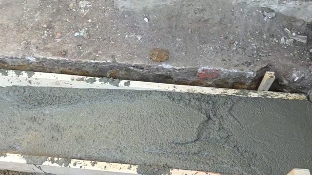 Foundation repair in progress with steel piers and hydraulic lifting equipment raising a settled residential foundation