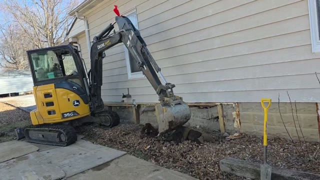 JLB crew performing a full residential foundation repair with steel push piers and hydraulic lifting equipment