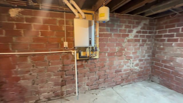 JLB Foundation Repair crew documenting pier placement, hydraulic lifting, and measurement verification on a jobsite