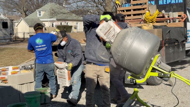 Steel push piers being driven through soil to load-bearing strata beneath a residential foundation by JLB