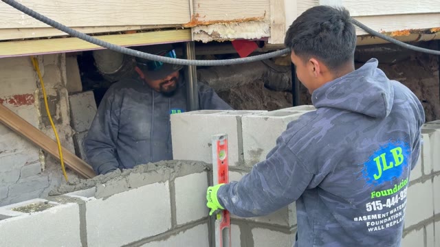 JLB Foundation Repair crew working on an active residential foundation repair jobsite with excavation and pier equipment