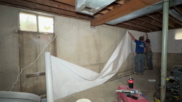 Vapor barrier installation in a crawlspace and basement encapsulation project showing moisture sealing by JLB